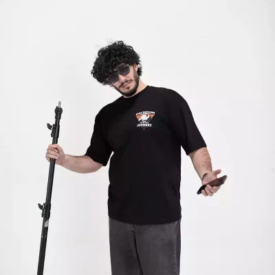 Model wearing a black journey t-shirt for men - new summer collection