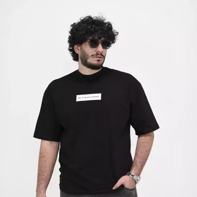 Model wearing a black nice human t-shirt for men - new summer collection