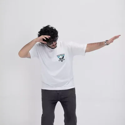 Model wearing a white journey t-shirt for men - new summer collection