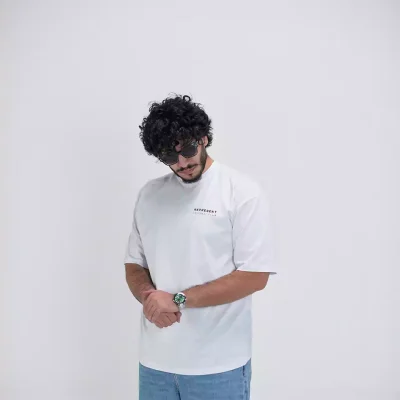 Model wearing a white represent t-shirt for men - new summer collection